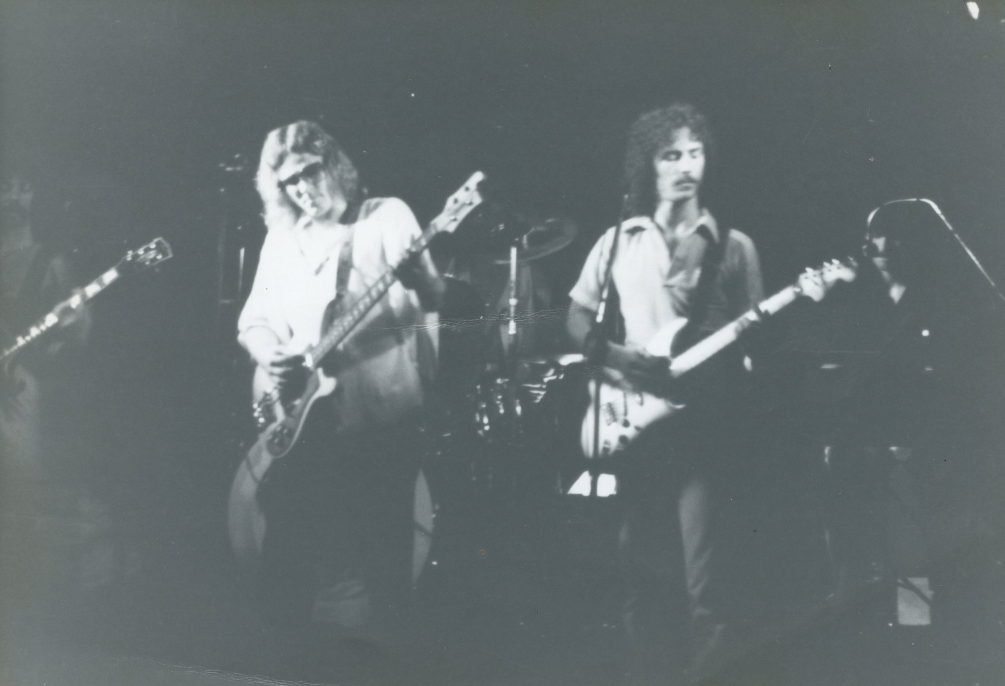 Black and white live band photo featuring Mike Mancour in an earlier era.